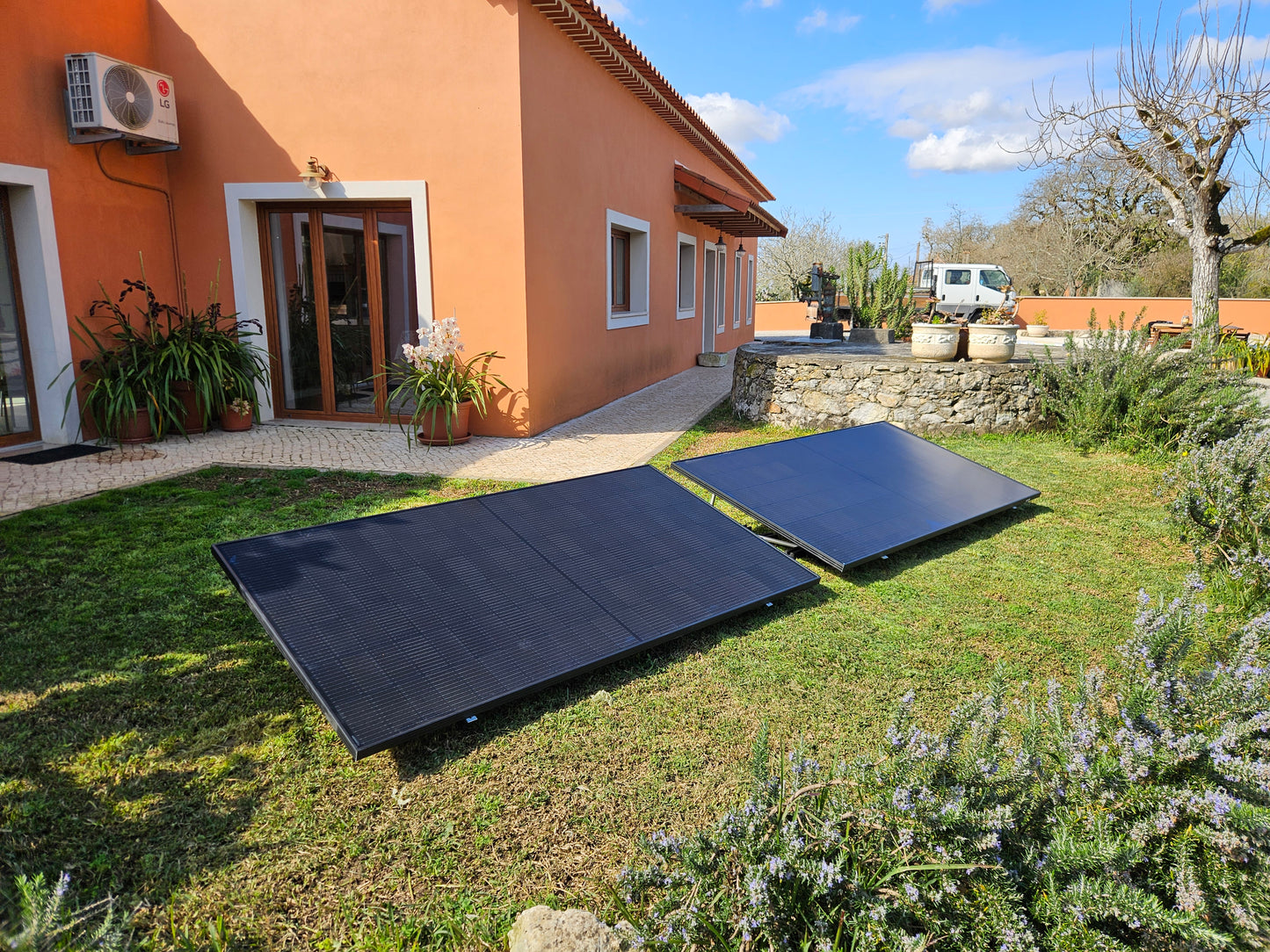 Kit solar plug and play instalado no jardim com dois painéis solares fotovoltaicos para autoconsumo residencial em Portugal